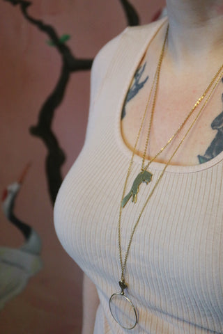 Antique golden opticians test lens necklace