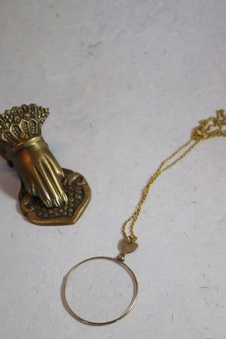 Antique golden opticians test lens necklace