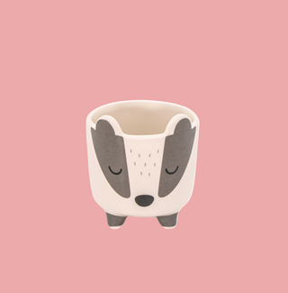 Ceramic planter shaped like a badger on a white background