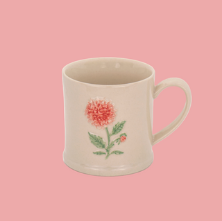 Ceramic mug with floral design on a white background