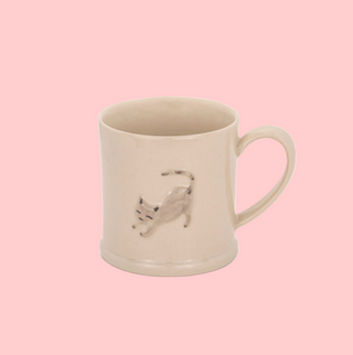 Beige mug with a cat design on a white background