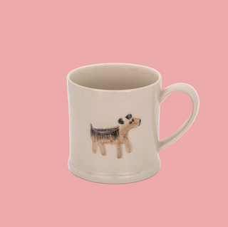 Beige mug with a dog illustration on a white background